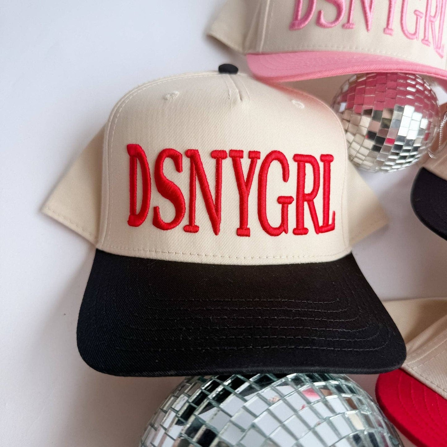 DSNYGRL - Trucker Hat: Black and cream with red thread